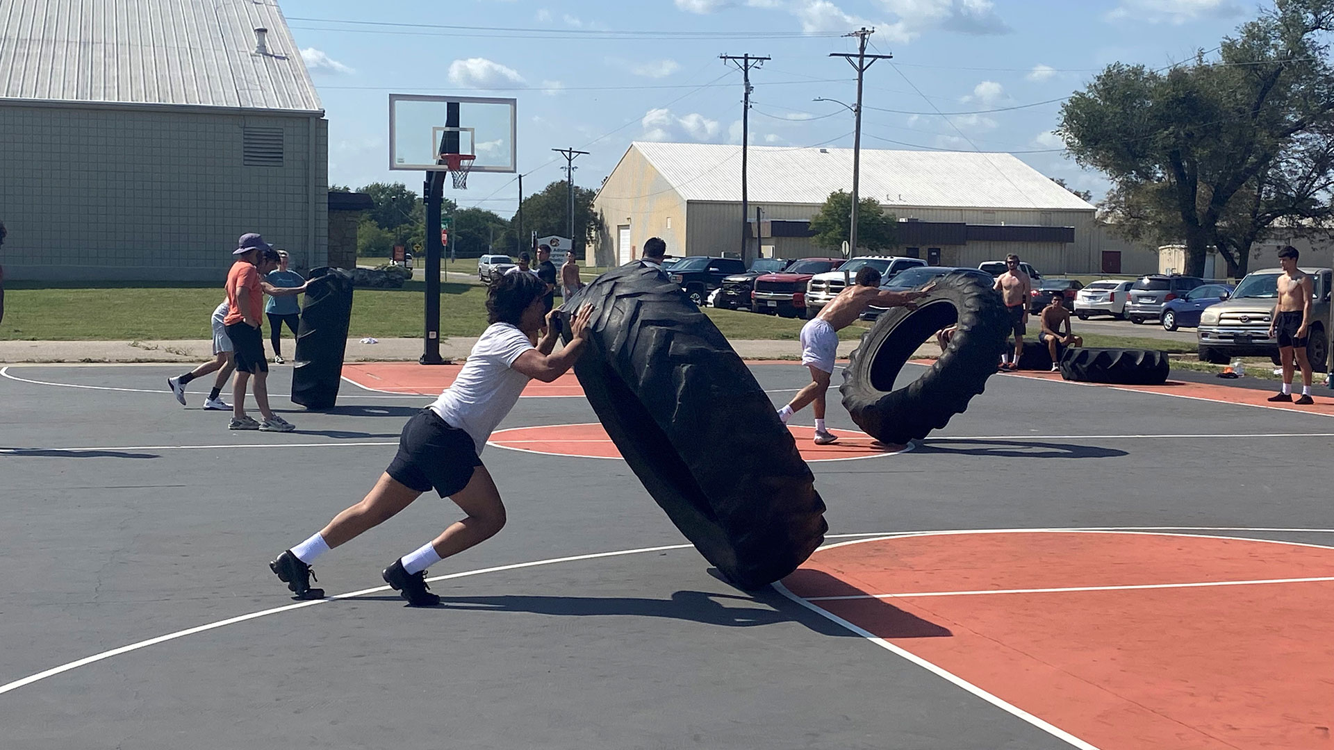 wrestlers doing a tire lifting workout