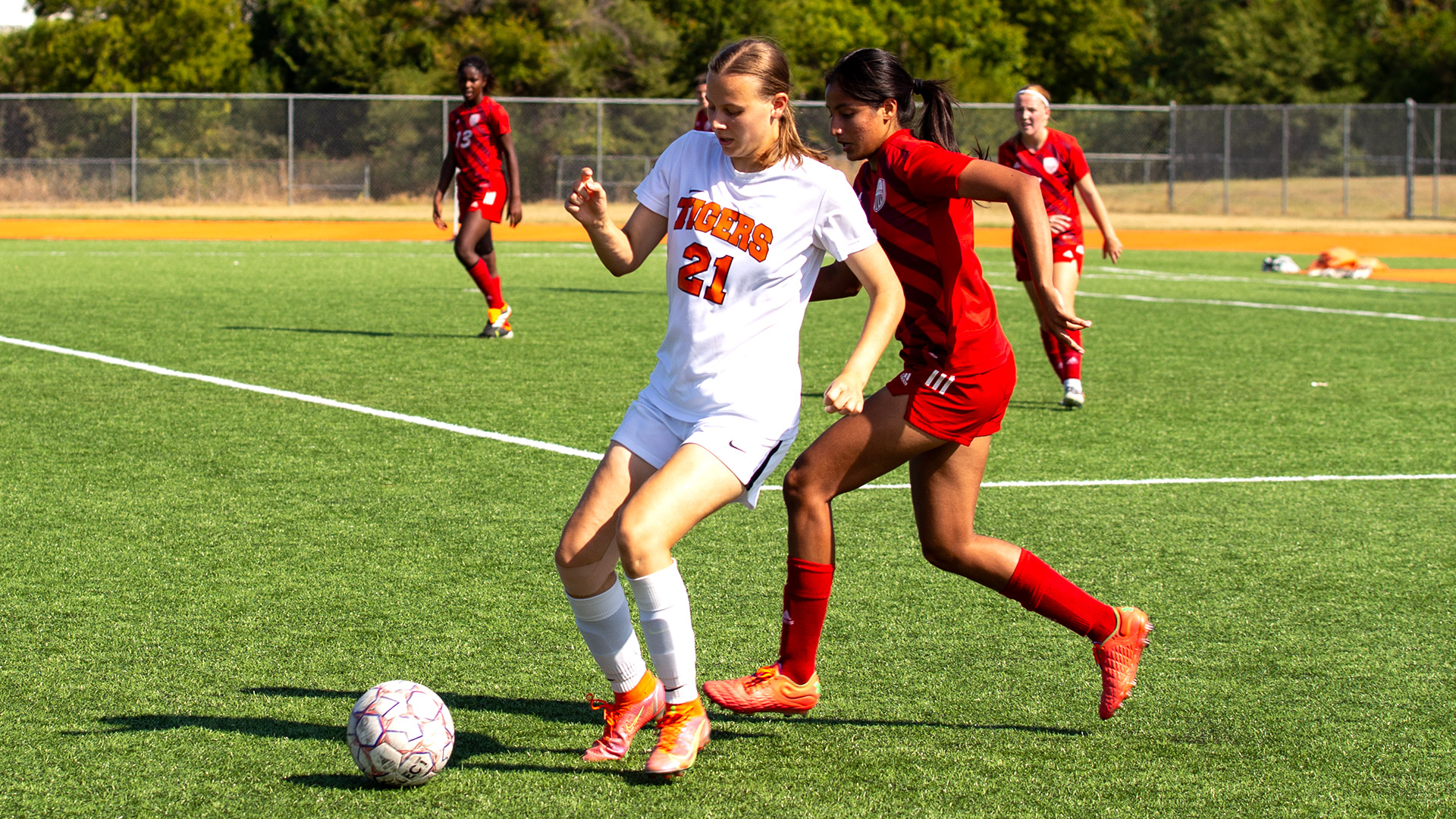 soccer players competing for the ball