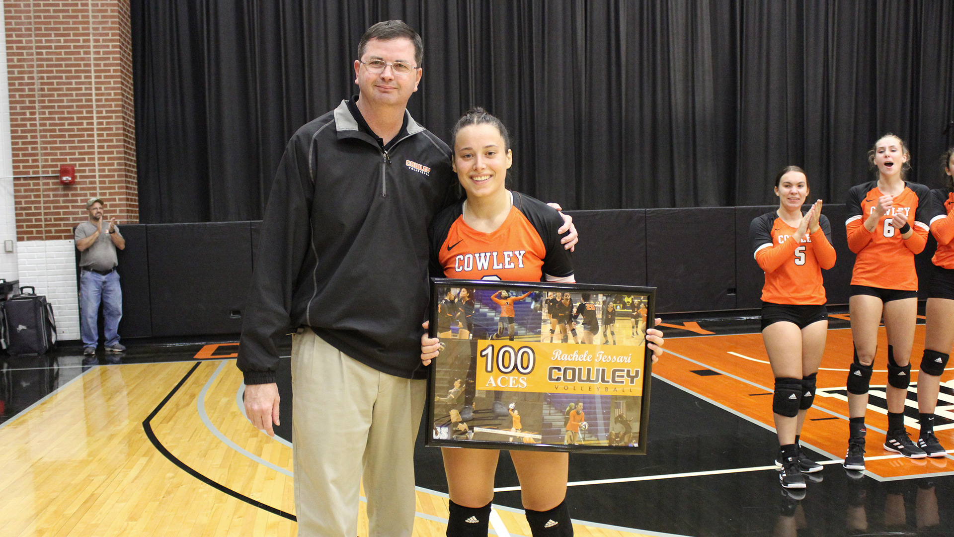 Coach Gream presenting Rachele Tessari with a plaque for reaching 100 career service aces